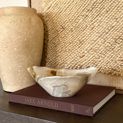 Natural olive onyx decorative bowl on table as home decor accent