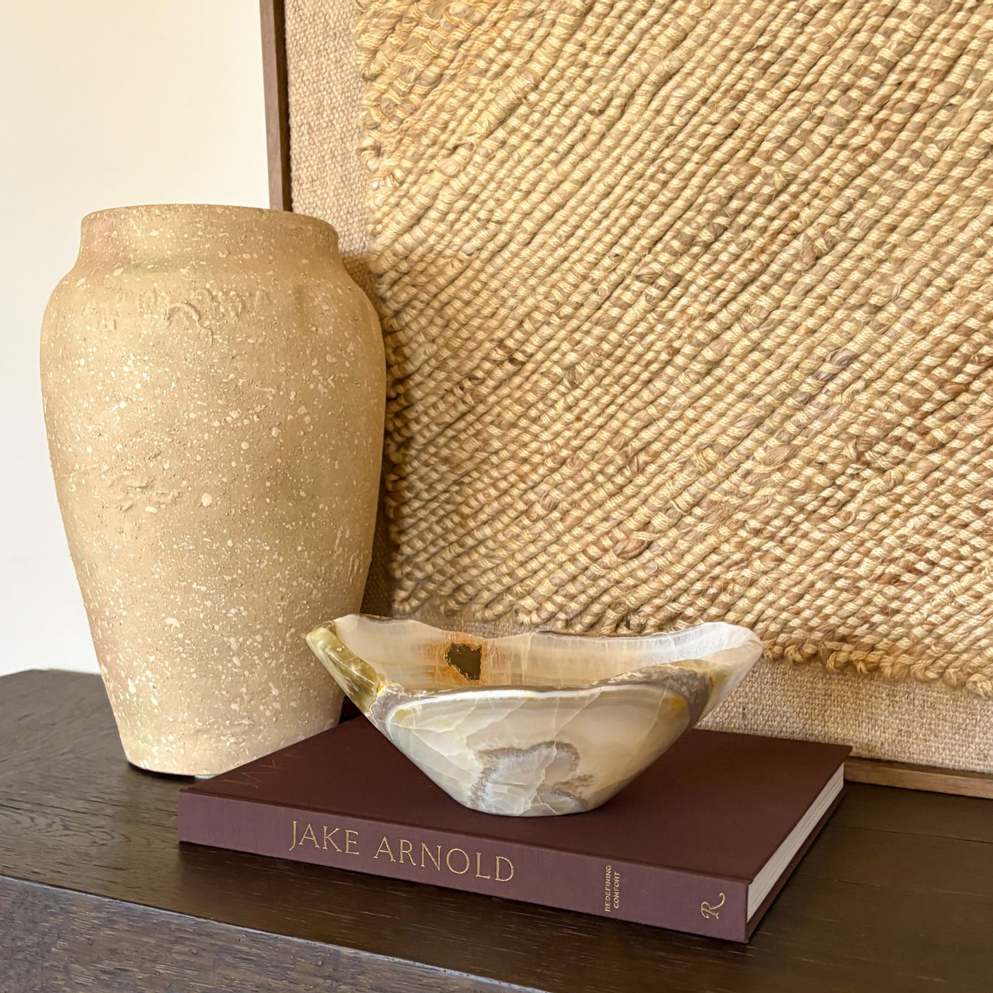 Hand carved olive onyx bowl displayed as a decorative centerpiece on a table