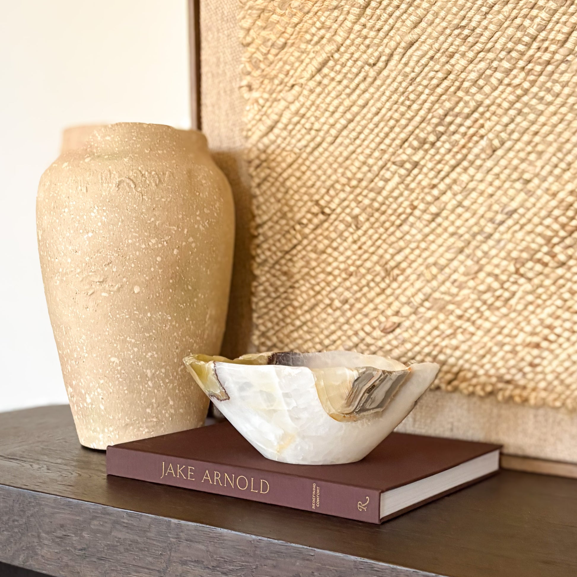 Hand carved olive onyx bowl styled as a decorative centerpiece in a modern home