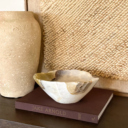 Close-up of hand carved olive onyx bowl showing natural stone patterns and polish