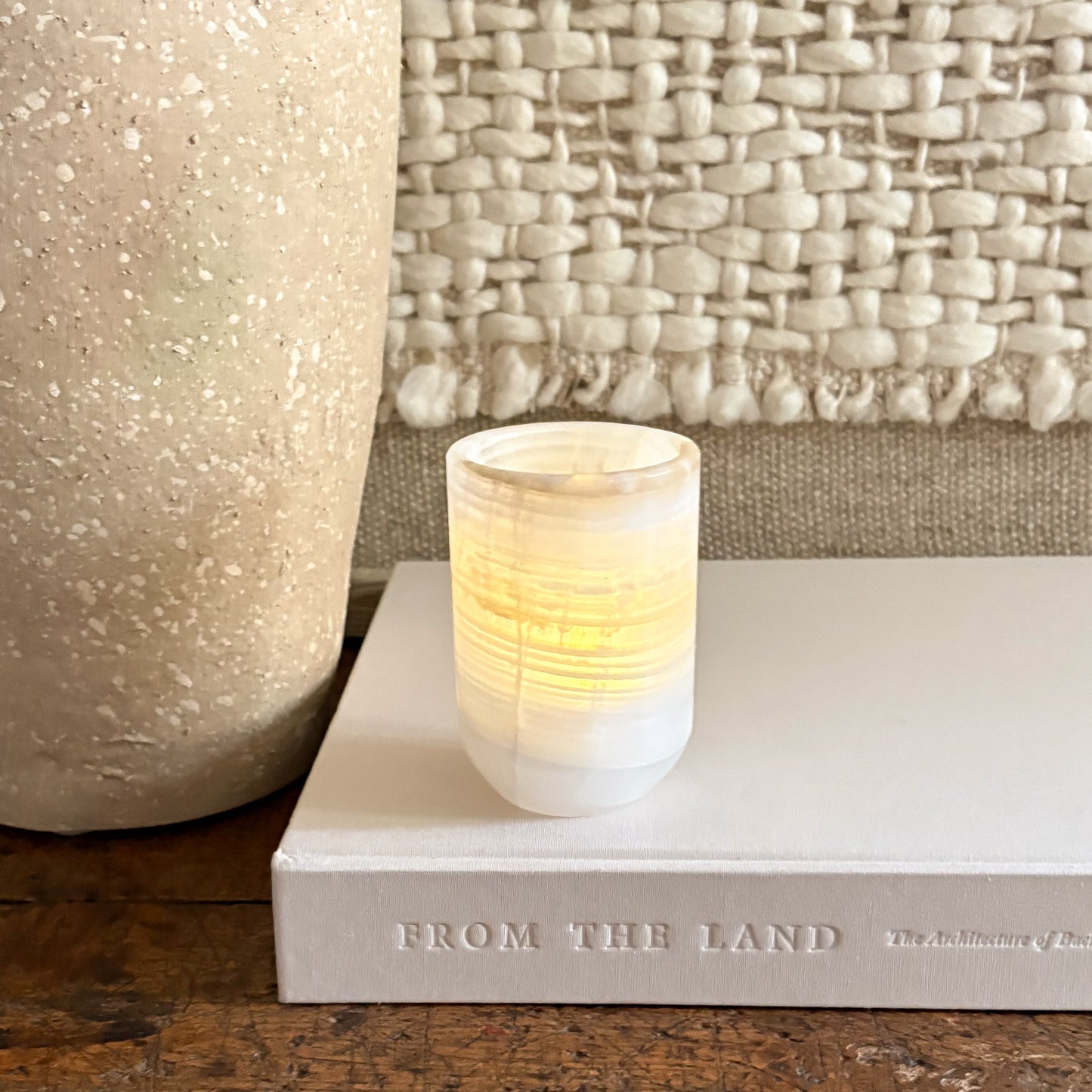 natural white onyx cylinder candle holder with lit votive
