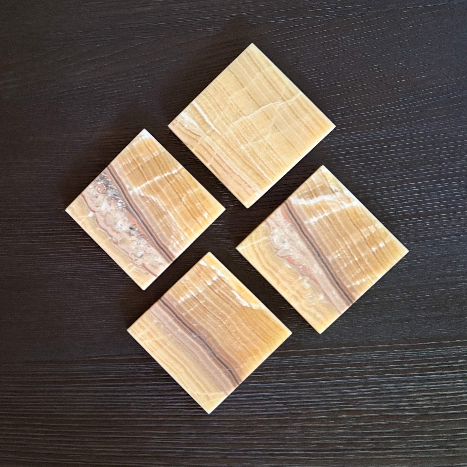 Polished orange onyx drink coasters for sophisticated home entertaining