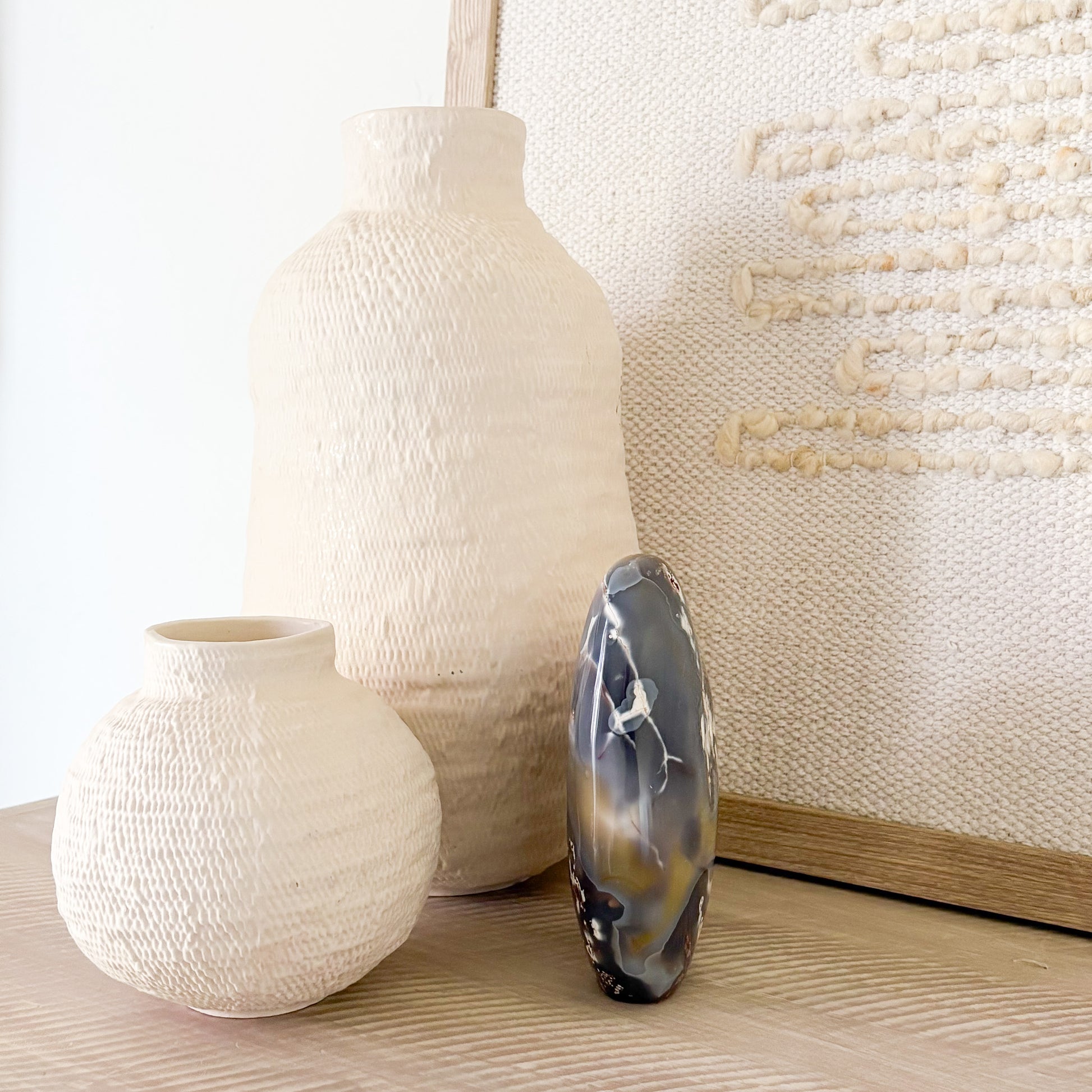 Natural orca agate stone decor on minimalist bookshelf