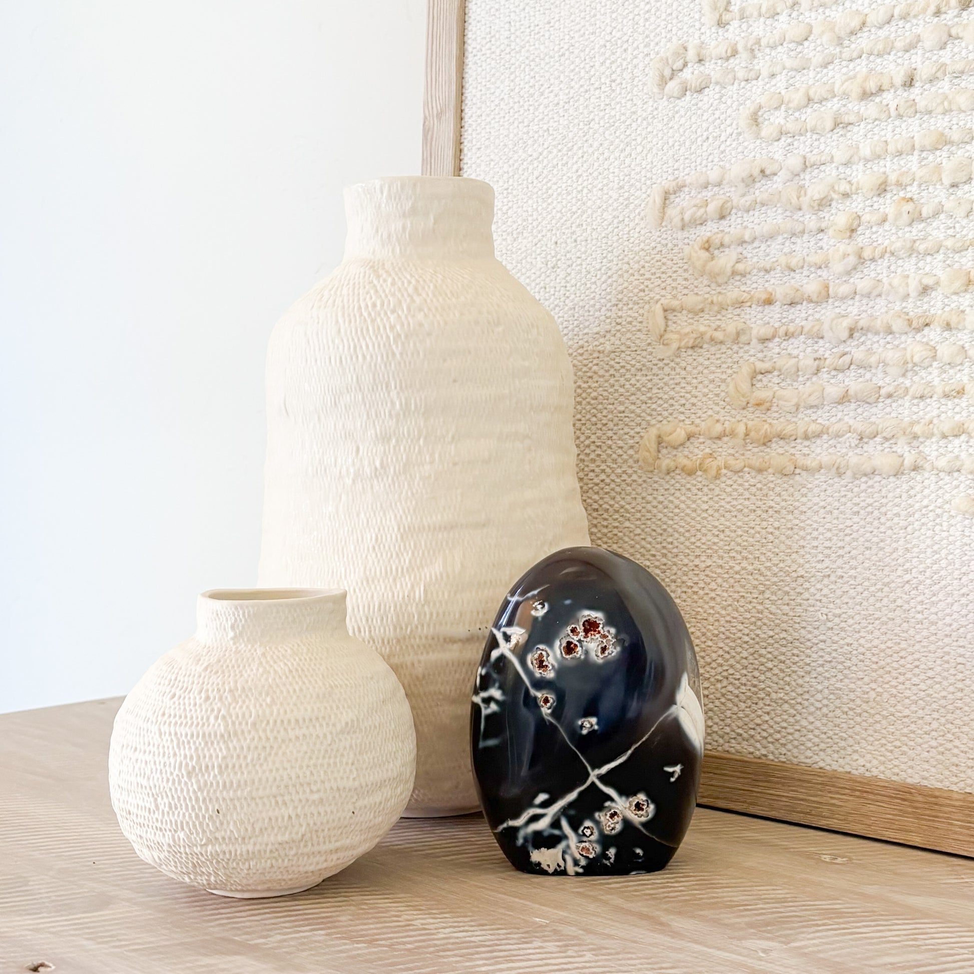 Orca agate sculpture with blue and white banding resembling ocean waves and orca whale pattern