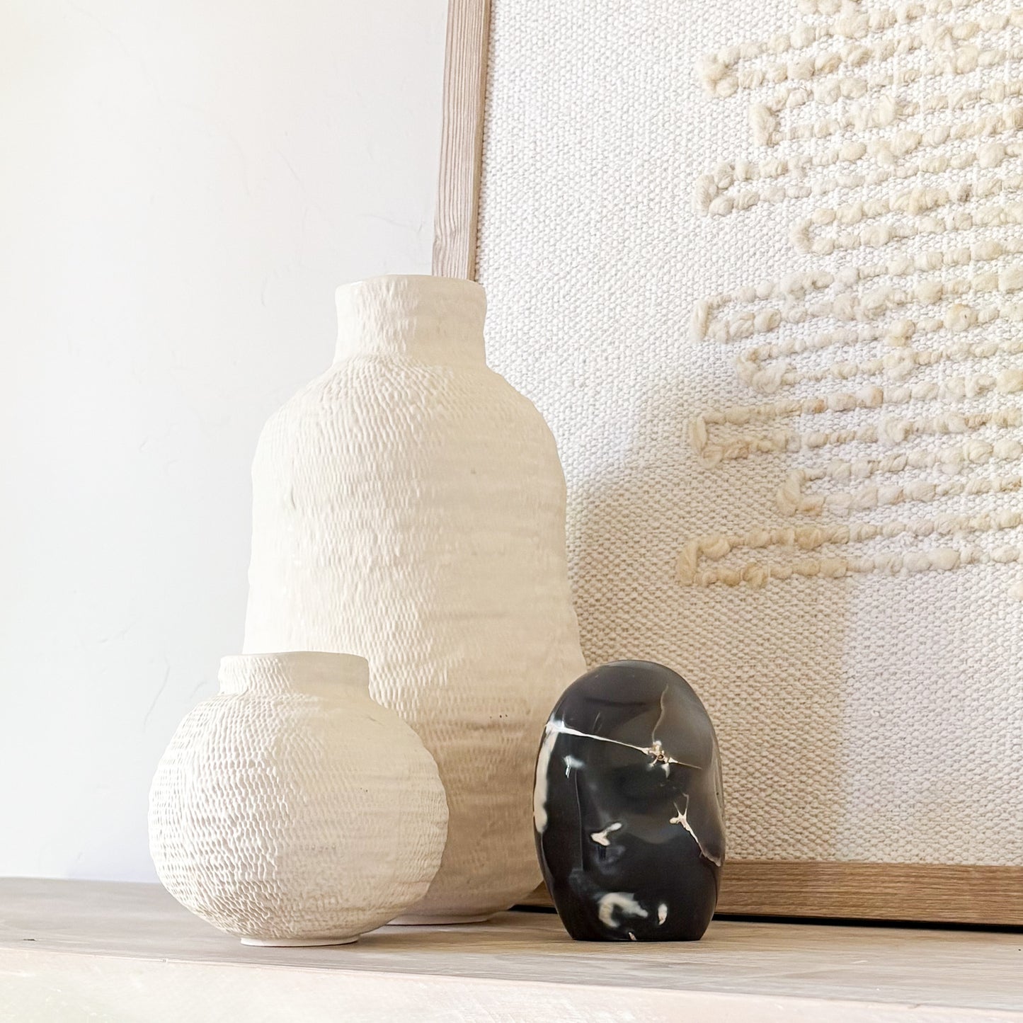 Elegant orca agate sculpture showcasing dramatic black, white, and gray swirls reminiscent of ocean currents