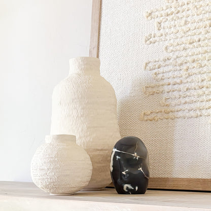 Elegant orca agate sculpture showcasing dramatic black, white, and gray swirls reminiscent of ocean currents