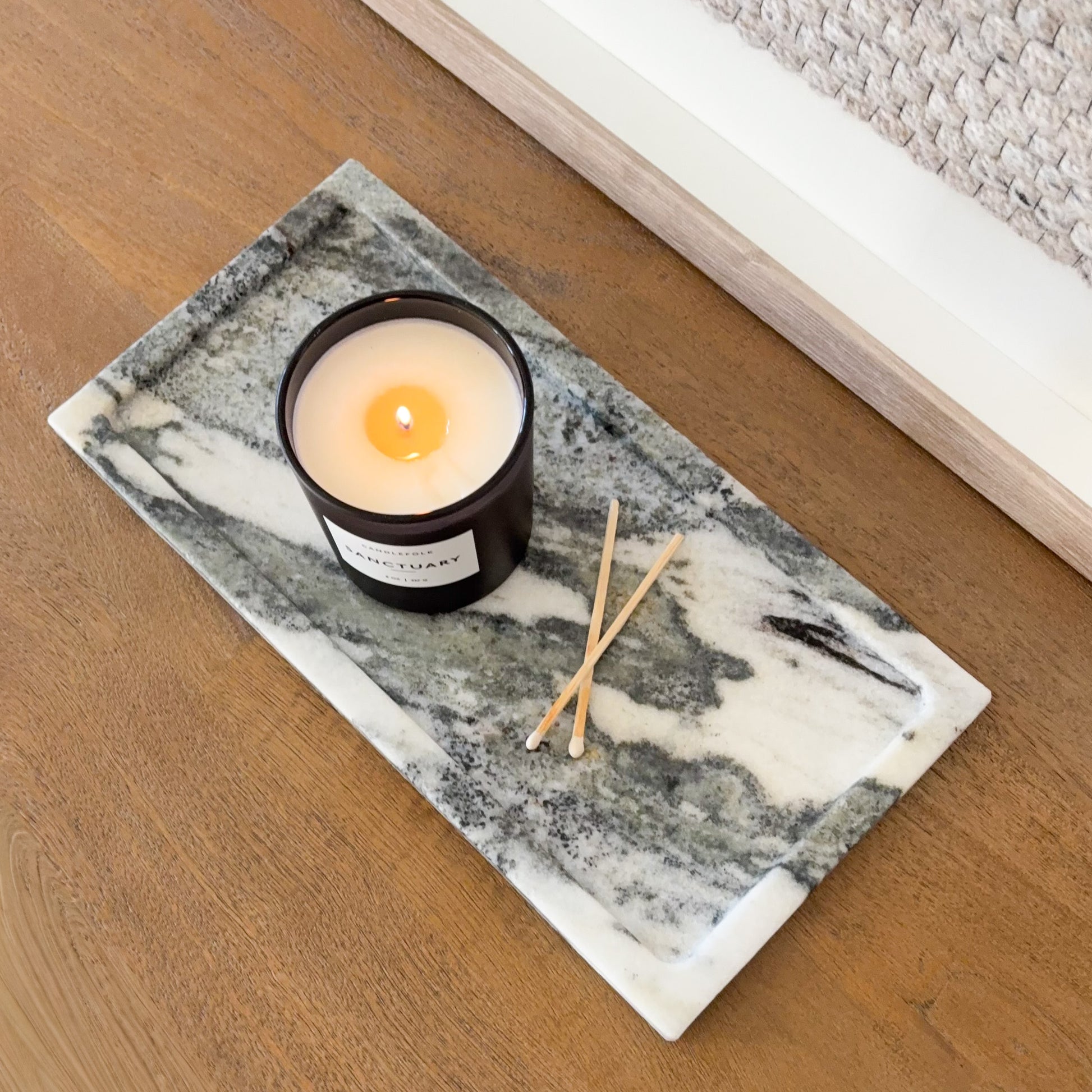 Panda marble tray with candle and matches on wooden table