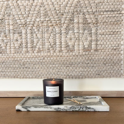 Rectangular black and white marble tray styled with candle
