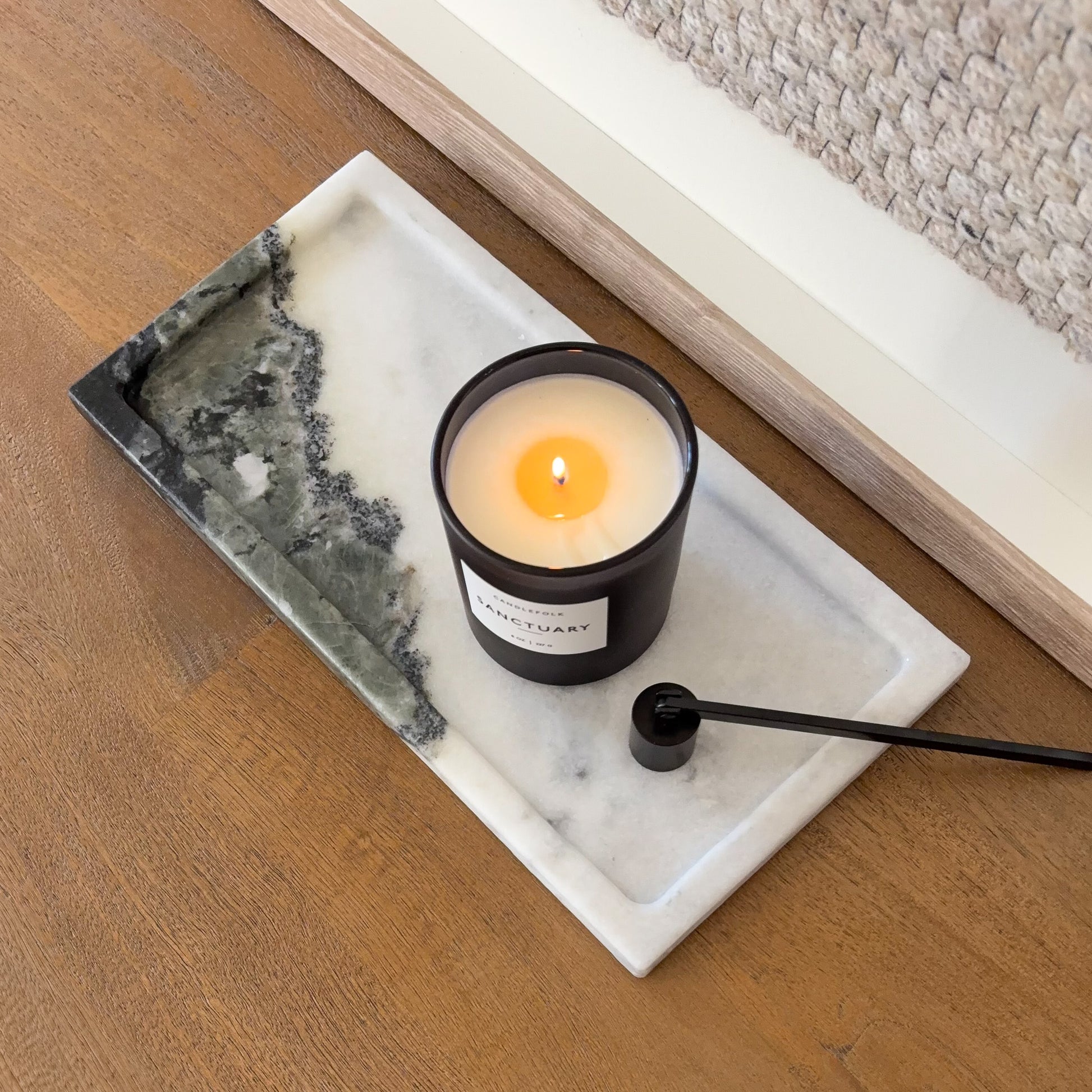Rectangular black and white marble tray styled with candle