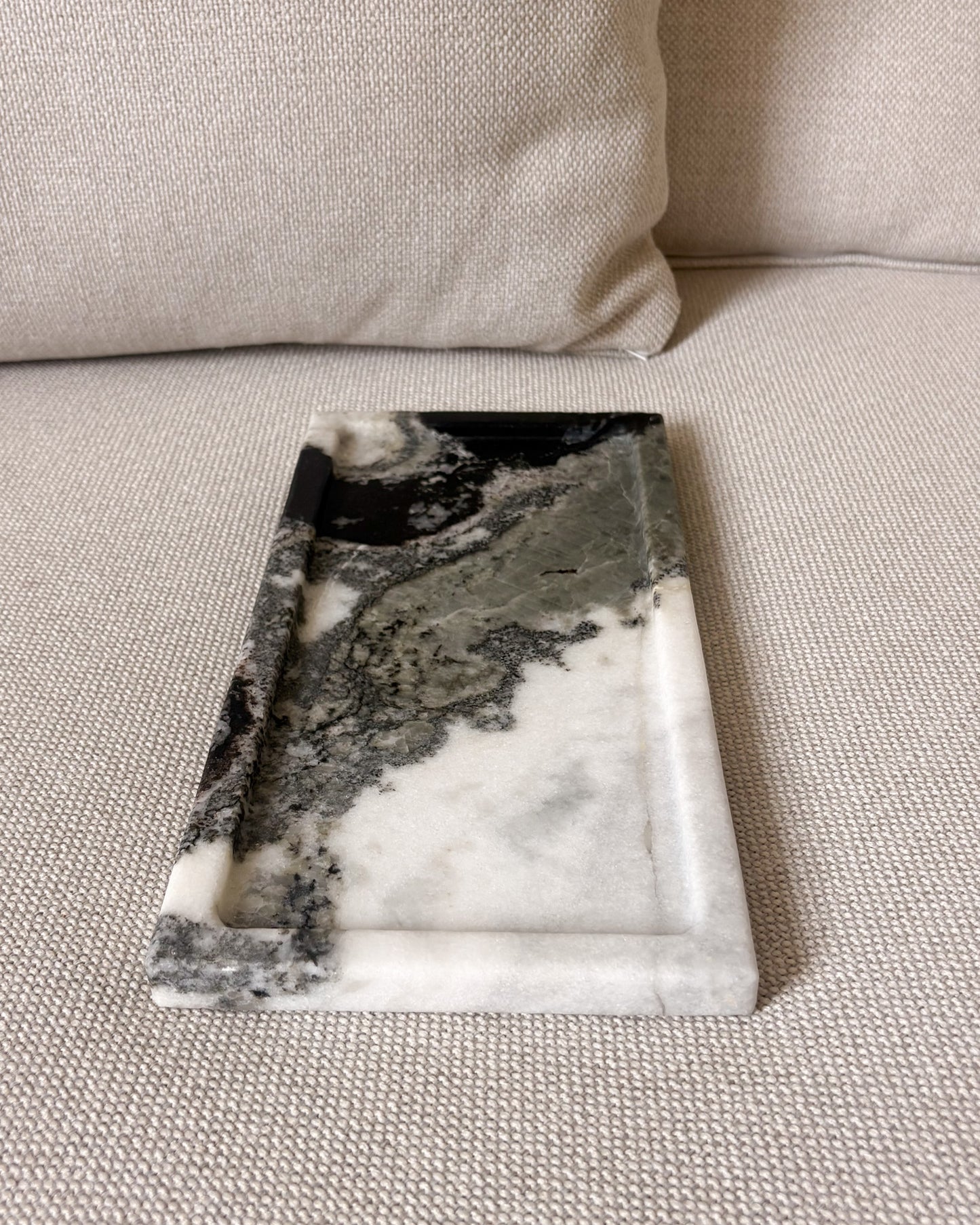Rectangular natural Panda marble tray with raised edges and unique stone pattern