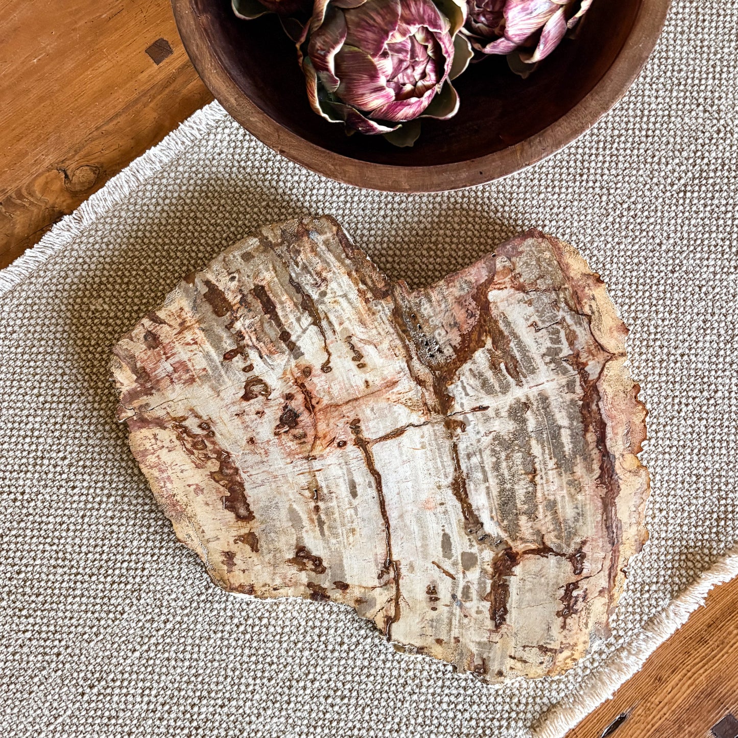 Handcrafted Indonesian petrified wood serving board featuring unique fossilized wood patterns
