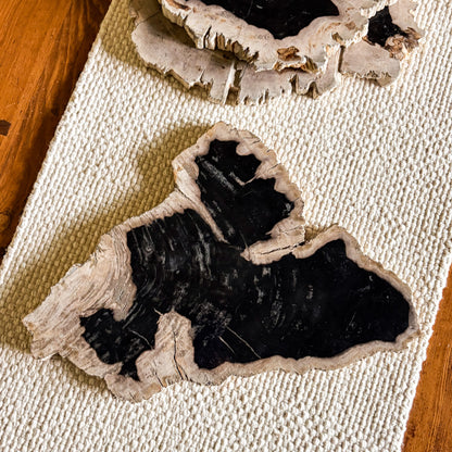 Rustic Indonesian petrified wood cutting and serving board with natural edge detail