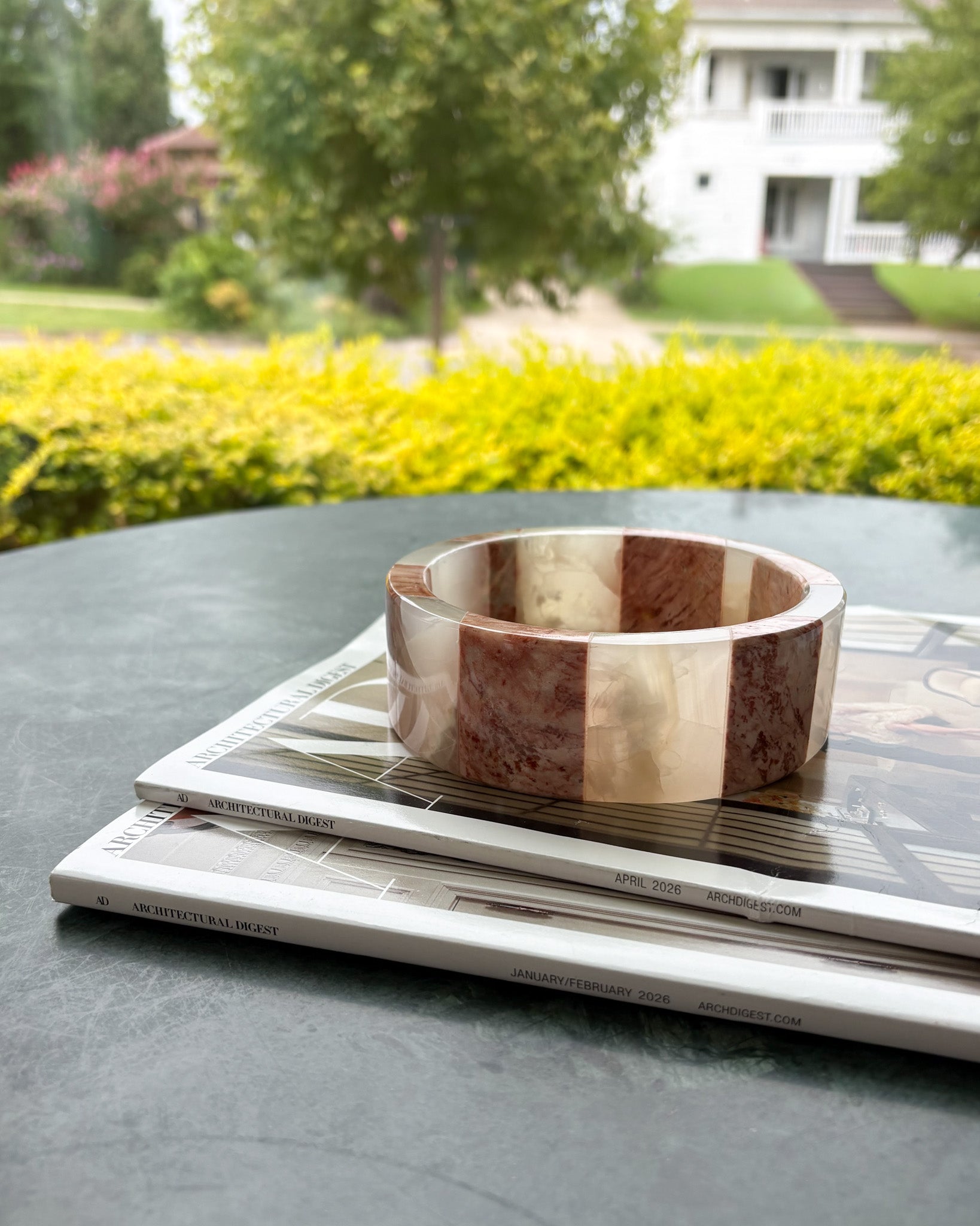 Decorative stone jewelry dish made from pink marble and white onyx