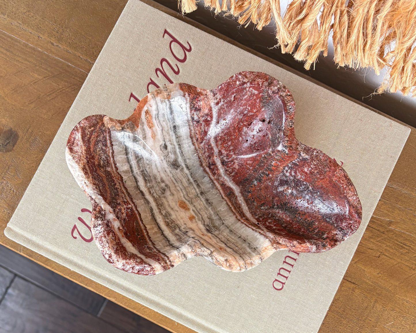Polished pink serpentine bowl with burgundy, cream and smoky grey veining