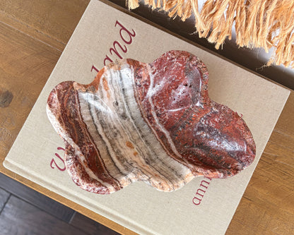 Polished pink serpentine bowl with burgundy, cream and smoky grey veining
