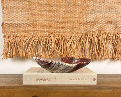 Hand-carved pink serpentine bowl with deep crimson and cream veining