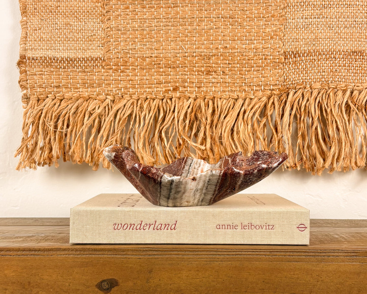 Sculptural pink serpentine stone bowl with rich crimson coloration