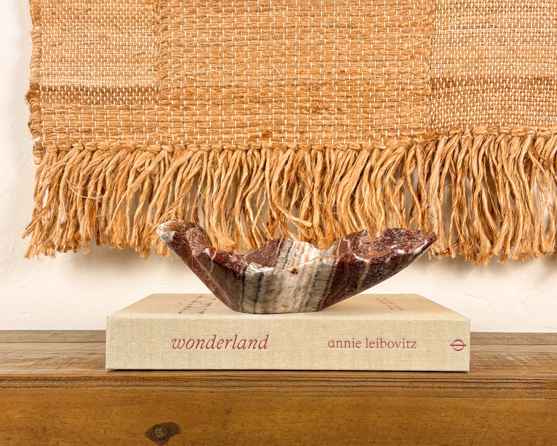 Sculptural pink serpentine stone bowl with rich crimson coloration