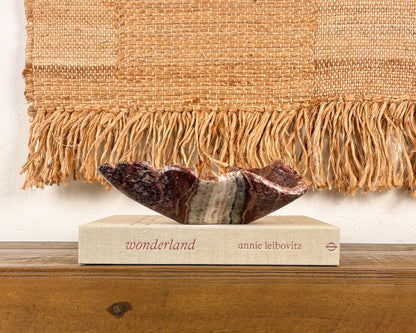 Hand-carved pink serpentine bowl with deep crimson and cream veining