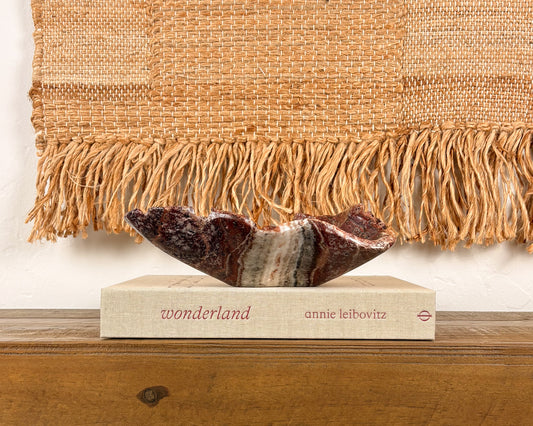 Hand-carved pink serpentine bowl with deep crimson and cream veining