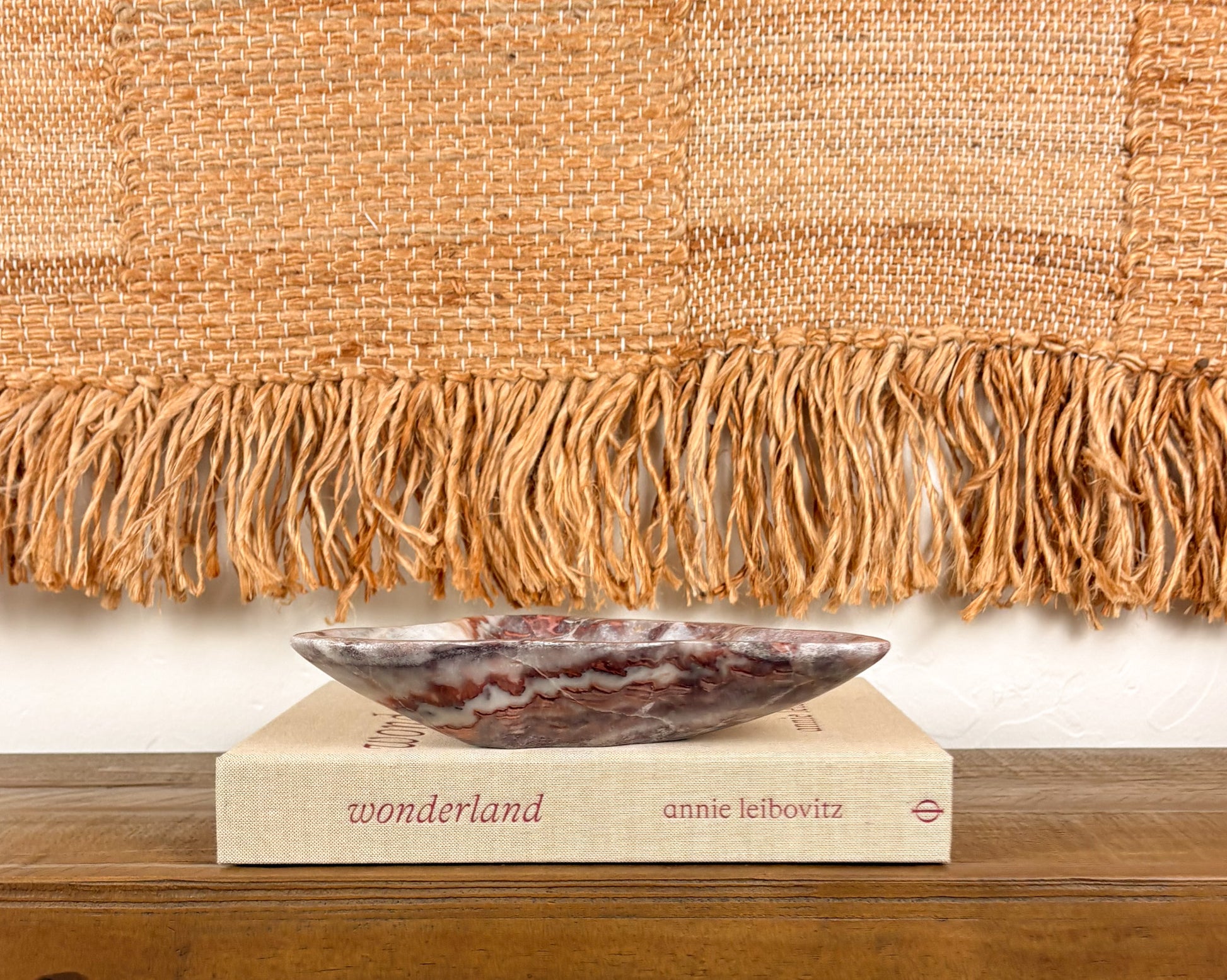 Hand-carved pink serpentine bowl with deep crimson and cream veining