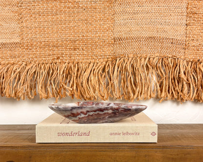 Hand-carved pink serpentine bowl with deep crimson and cream veining