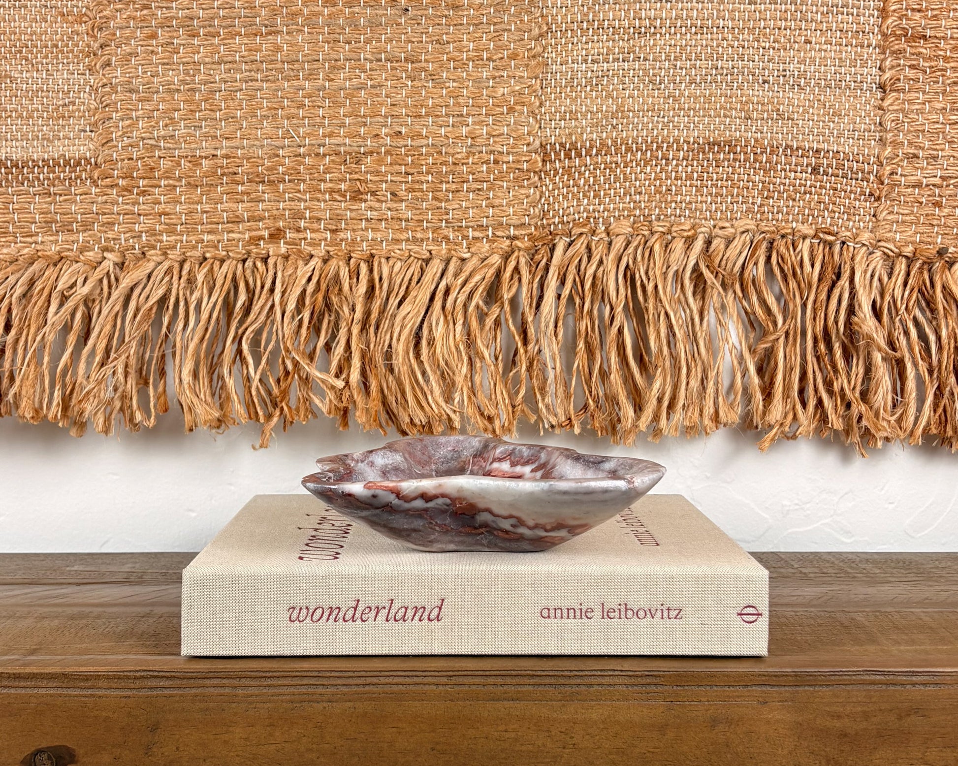 Sculptural pink serpentine stone bowl with rich crimson coloration