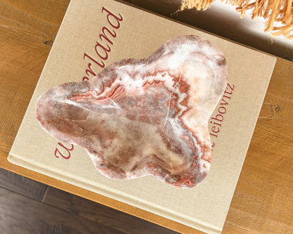 Polished pink serpentine bowl with burgundy, cream and smoky grey veining
