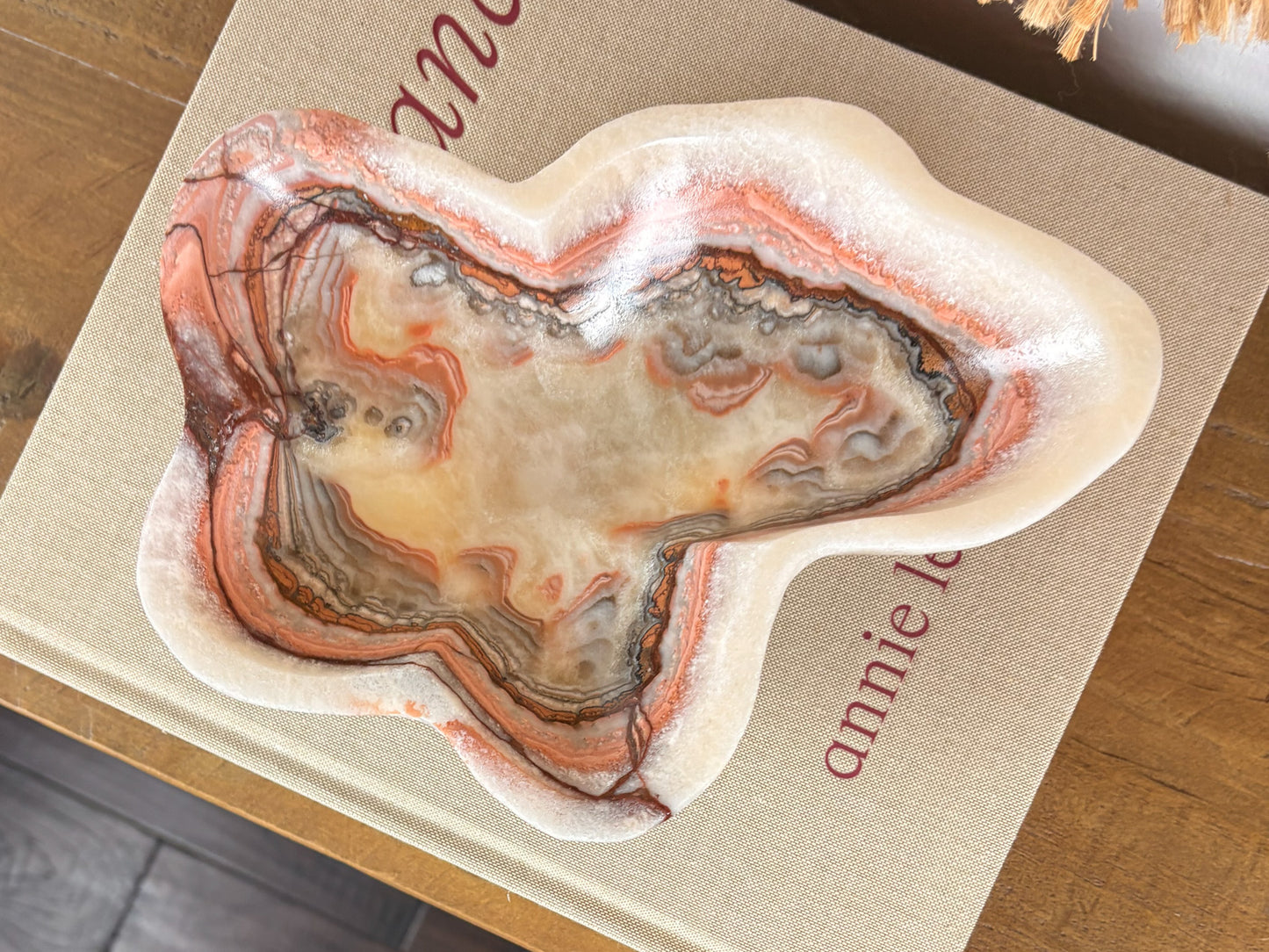 Deep pink serpentine stone bowl with distinctive cream and crimson veining