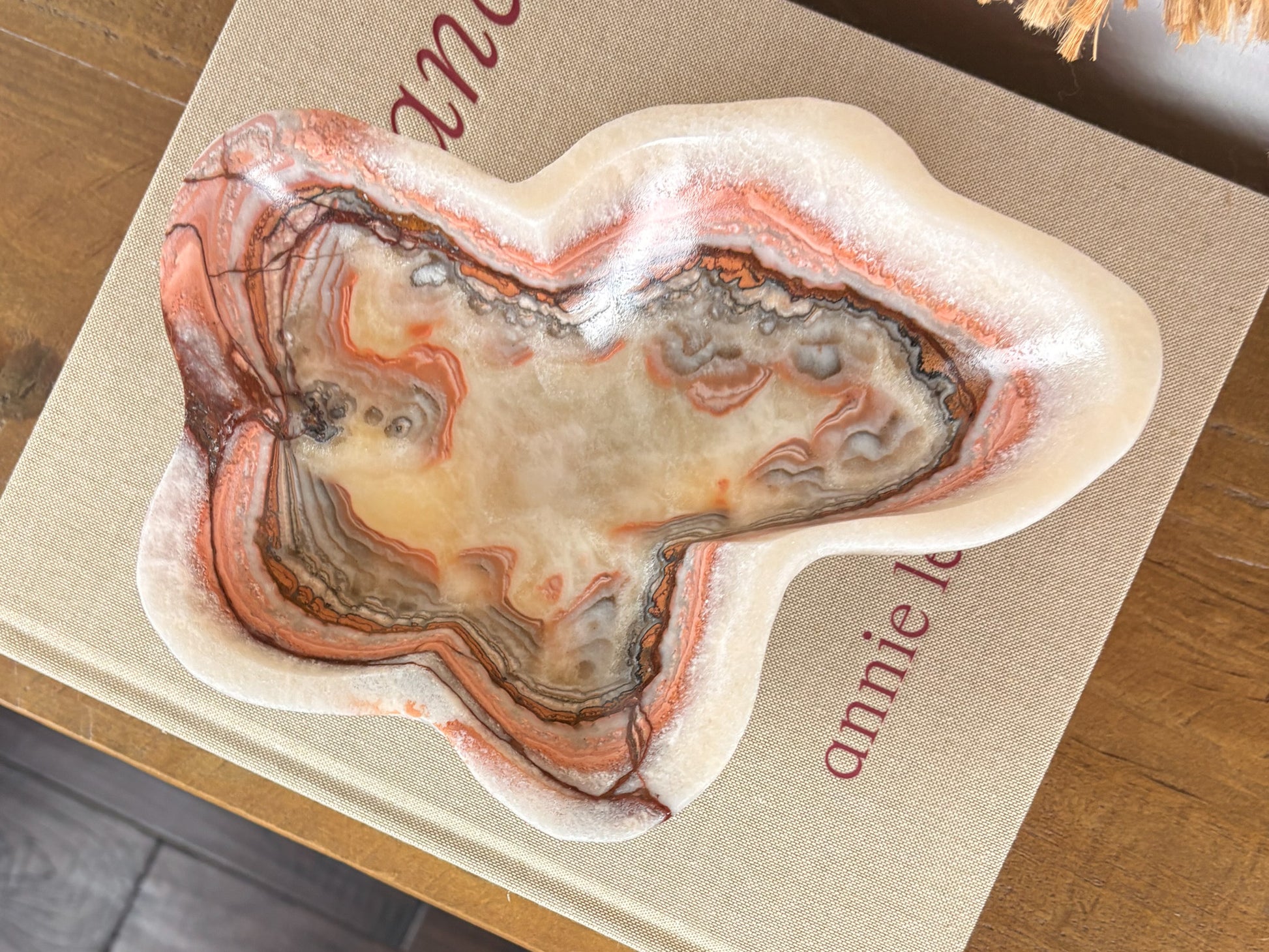 Deep pink serpentine stone bowl with distinctive cream and crimson veining