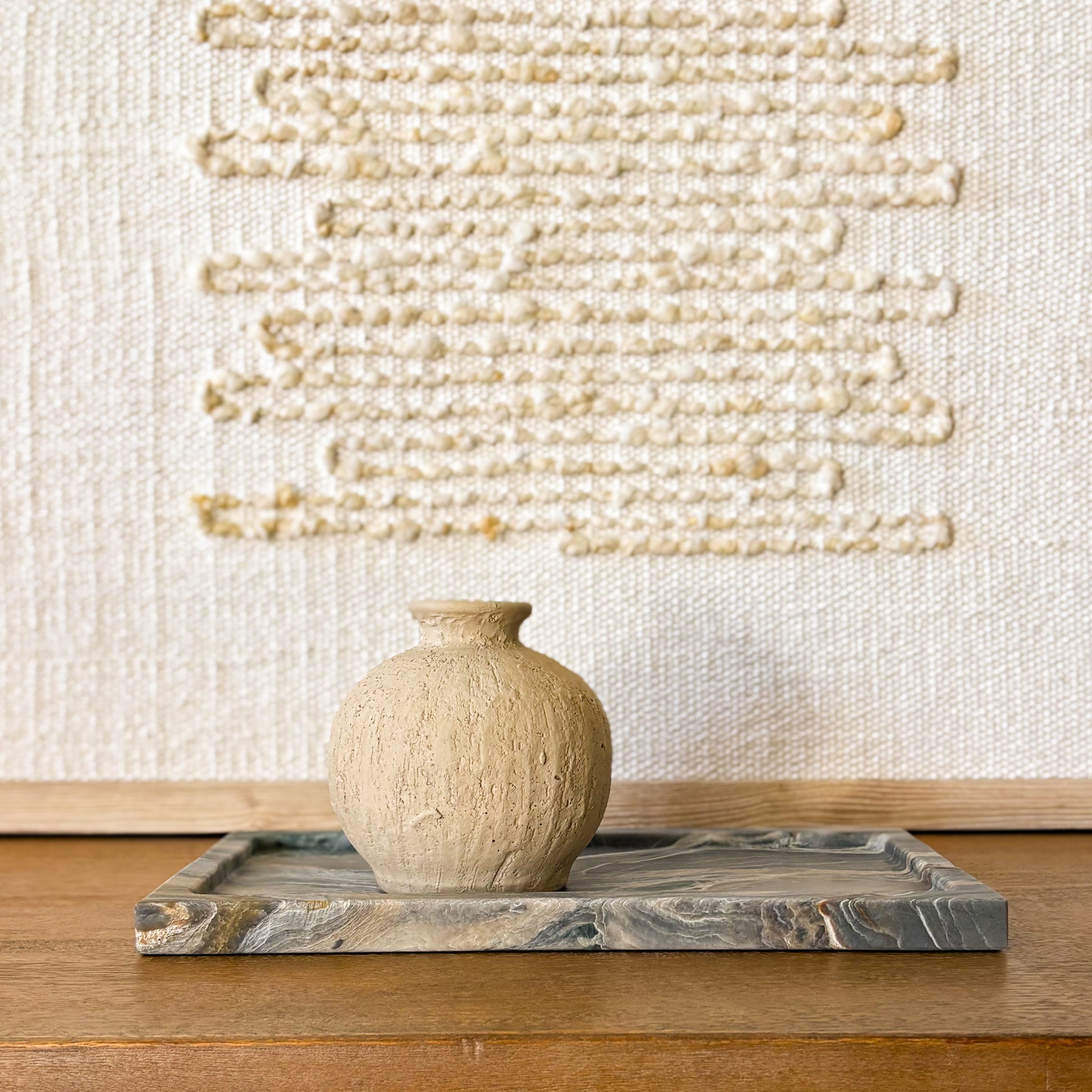 Pocahontas grey marble tray with natural veining on wooden table