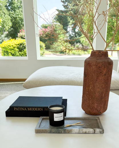 Decorative gray Pocahontas marble tray with candle on a modern coffee table in a luxury living room