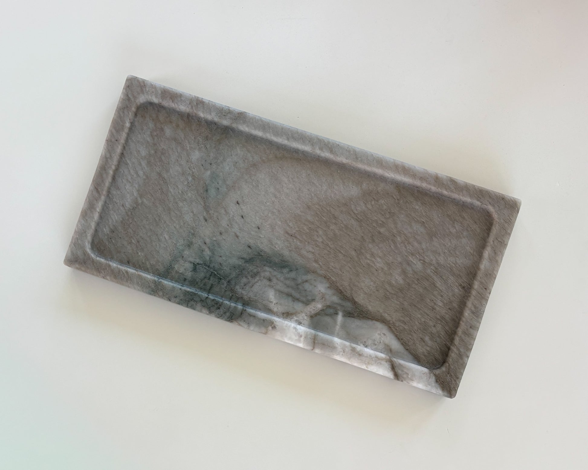 Top view of handcrafted gray Pocahontas marble tray with natural charcoal veining, candle, and matches