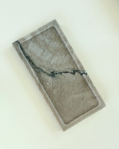 Handcrafted gray marble catchall tray with unique natural veining