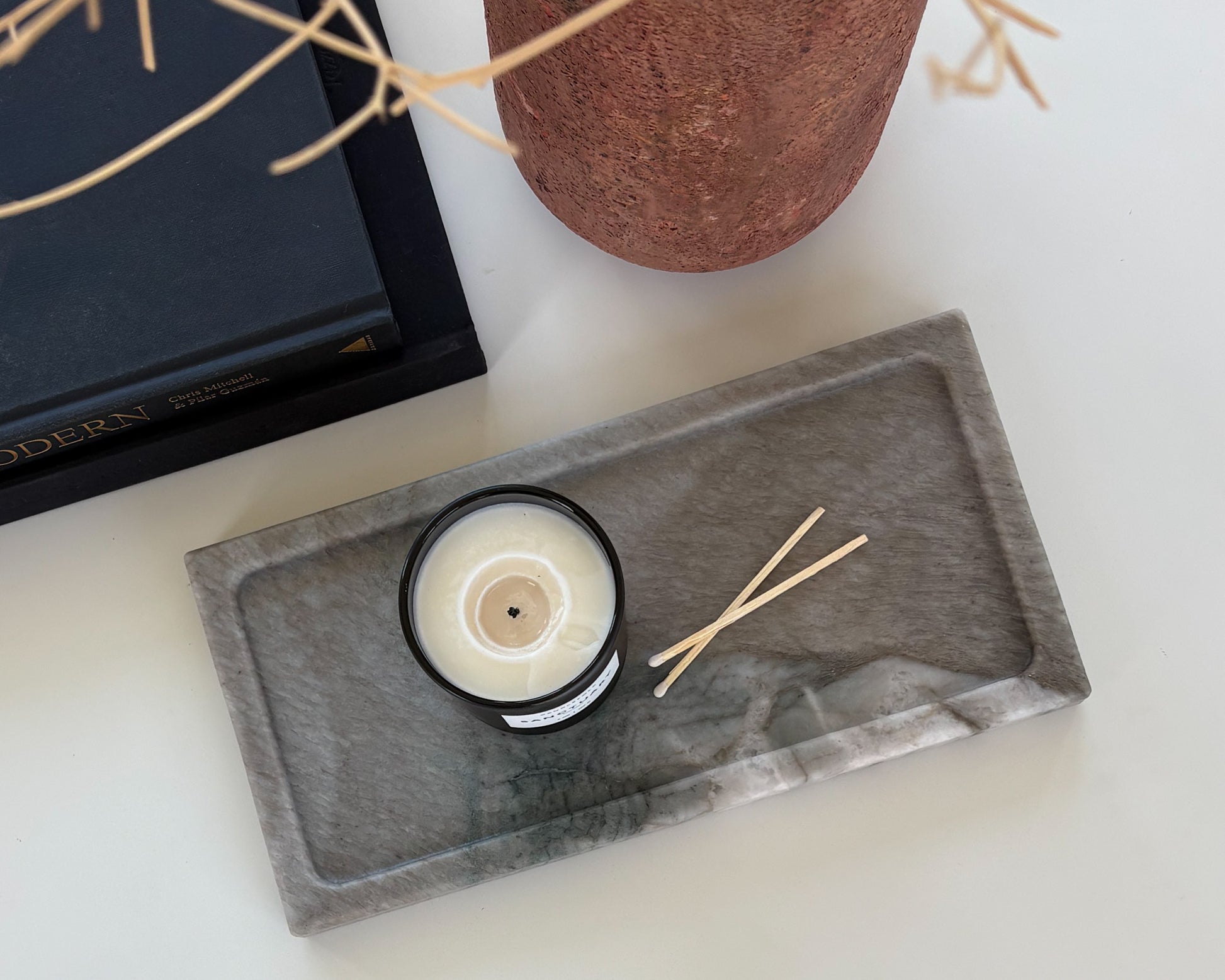 Natural gray Pocahontas marble tray styled with a black candle for modern organic home décor