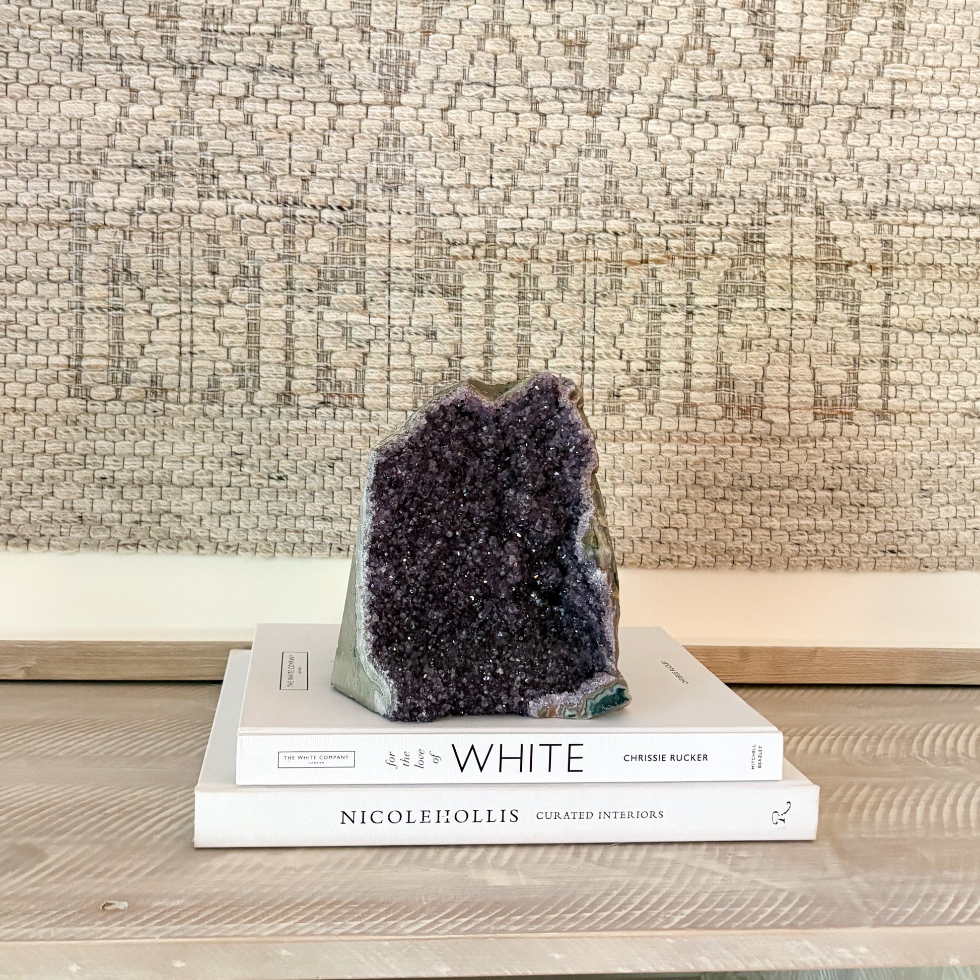 Geode on top of books with a textured wall background