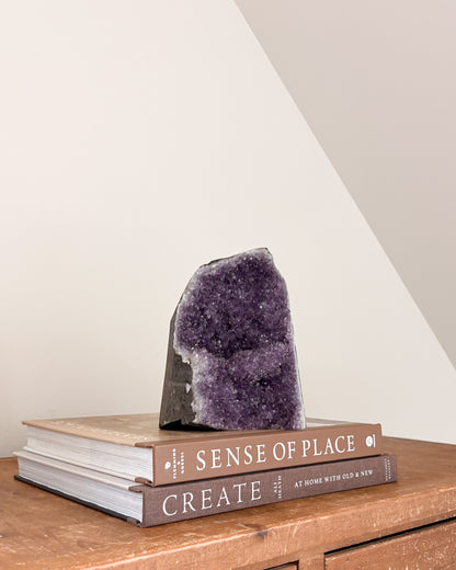 Natural rainbow amethyst geode with violet and lavender crystals