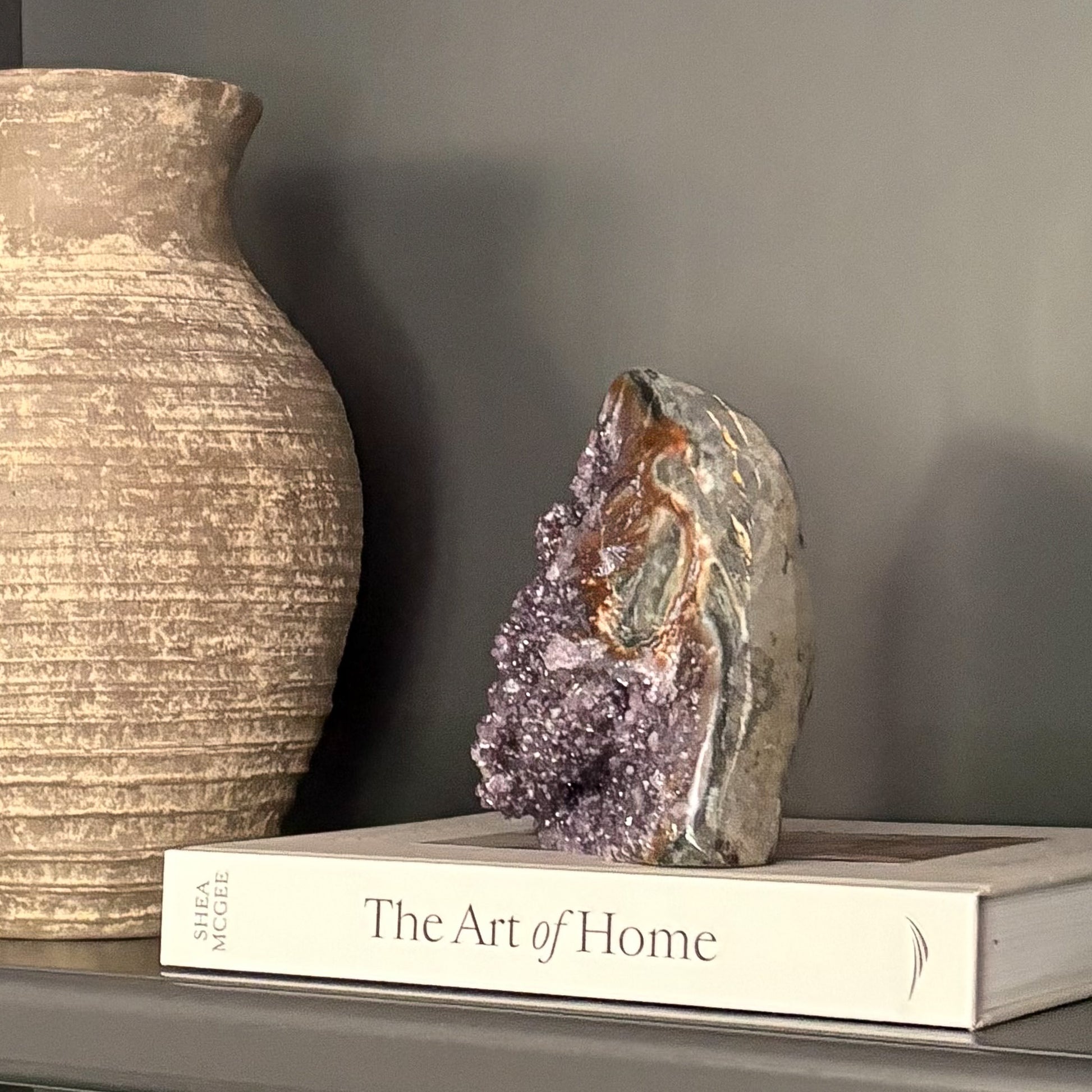 Luxury home décor with amethyst geode and neutral textured vase