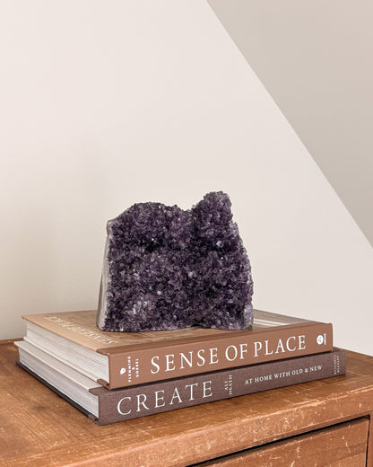 Natural amethyst geode with violet and smoky purple crystals