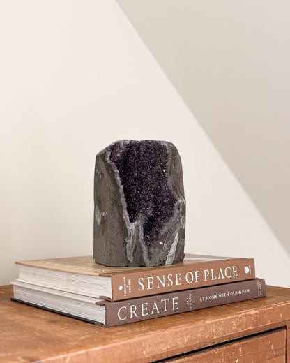 Rainbow amethyst geode with purple crystalline interior