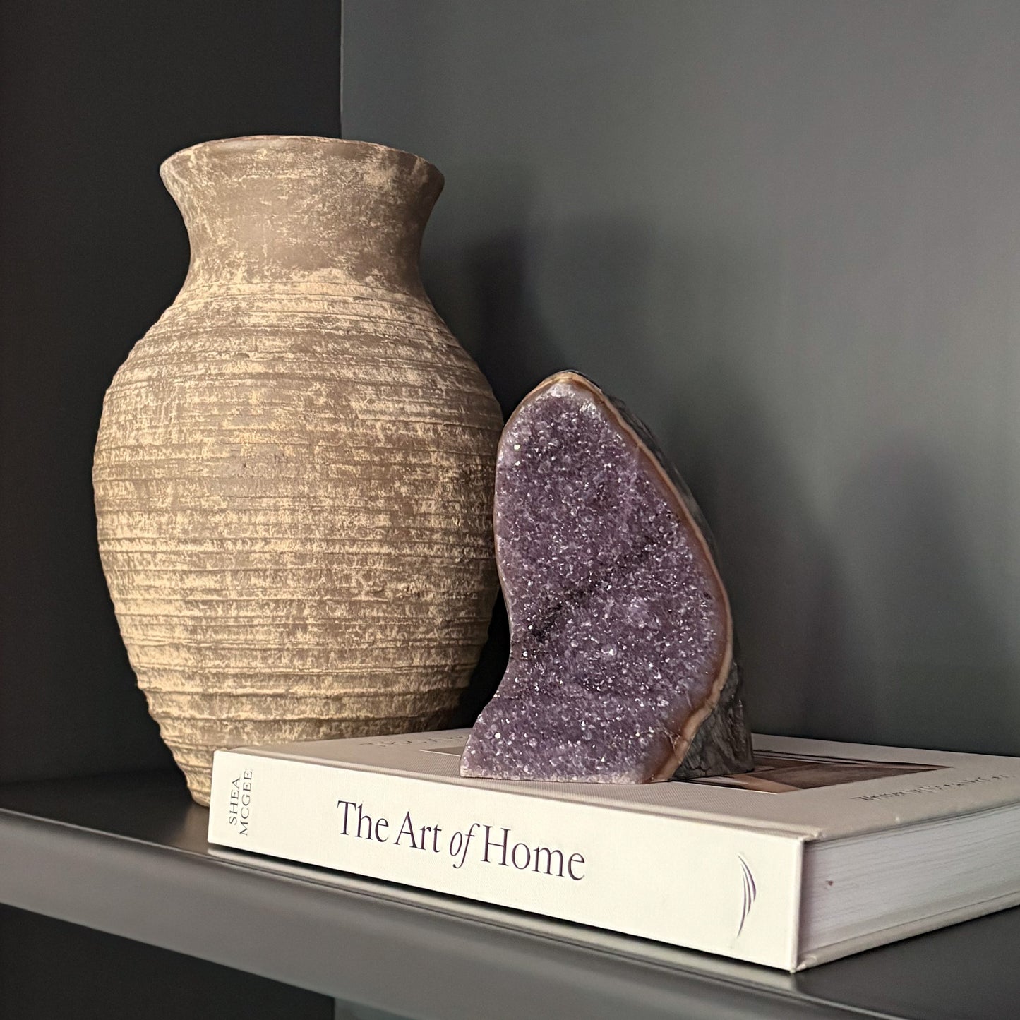 Luxury home décor with amethyst geode and neutral textured vase