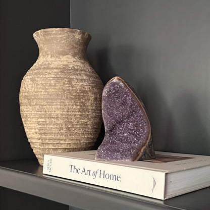 Luxury home décor with amethyst geode and neutral textured vase