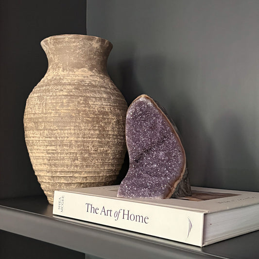Luxury home décor with amethyst geode and neutral textured vase