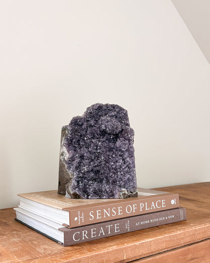 Rainbow amethyst geode with purple crystalline interior