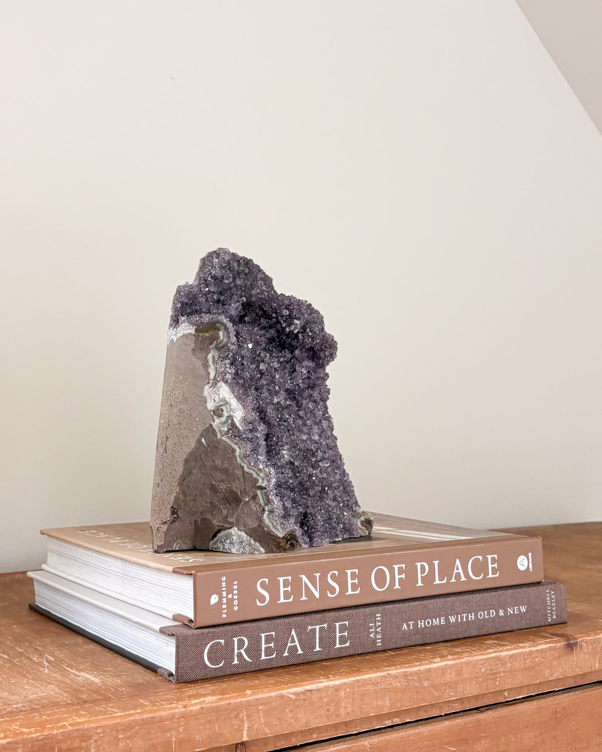 Natural rainbow amethyst geode with violet crystal formation
