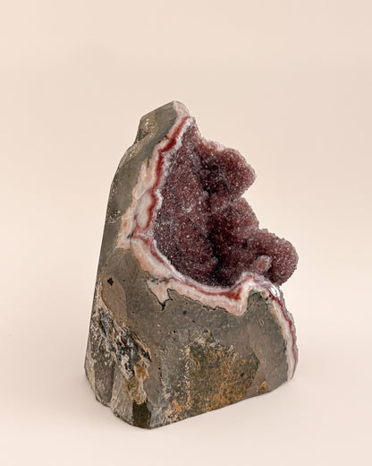 Natural amethyst geode displaying a crystalline interior and distinctive agate banding