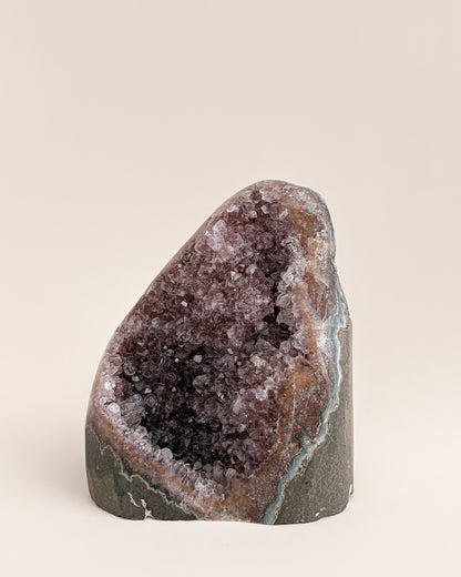 Natural amethyst geode displaying a crystalline interior and distinctive agate banding