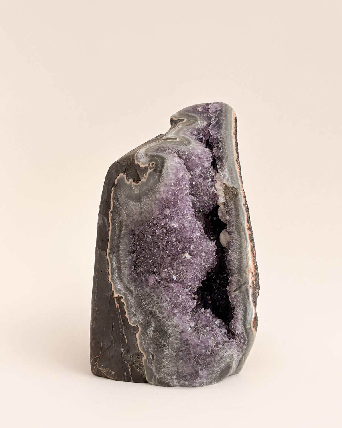 Freestanding amethyst crystal geode with delicate lavender and smoky purple tones