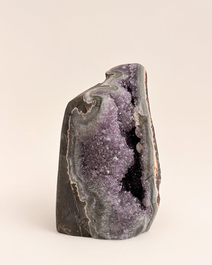 Freestanding amethyst crystal geode with delicate lavender and smoky purple tones