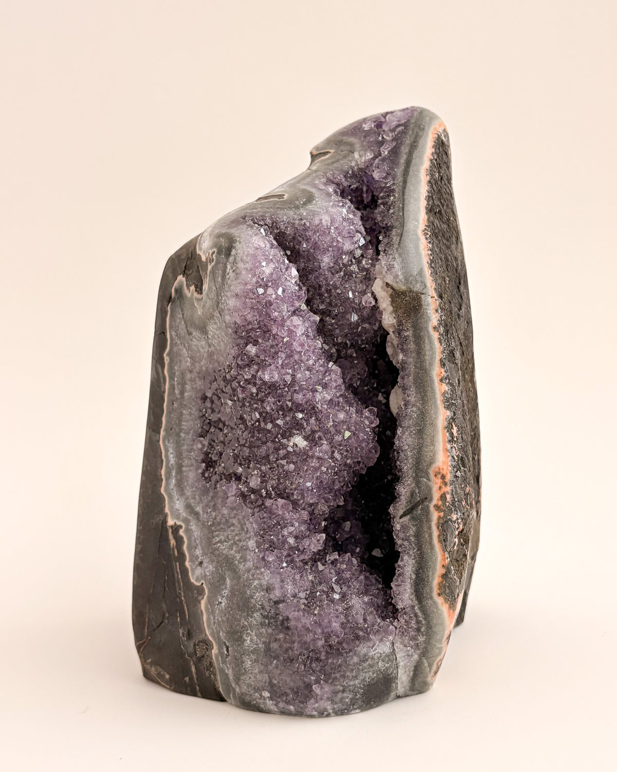 Natural amethyst geode displaying a crystalline interior and distinctive agate banding